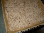 Pulverized almonds sprinkled on the tart dough