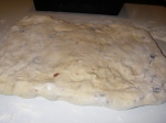 Raisin bread dough patted into a rectangle